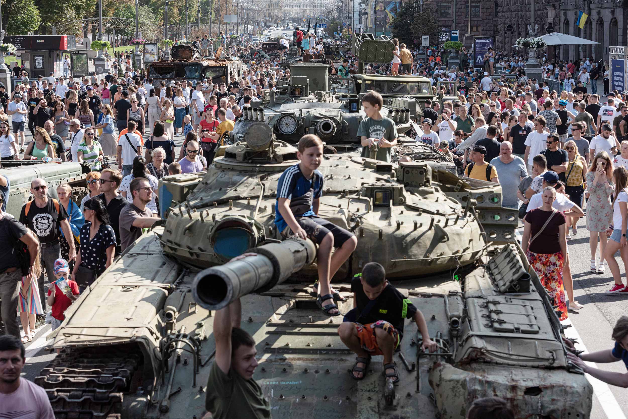 People walk by destroyed Russian tanks and military vehicles displayed in central Kyiv, Ukraine. © Alexey Furman/Getty Images