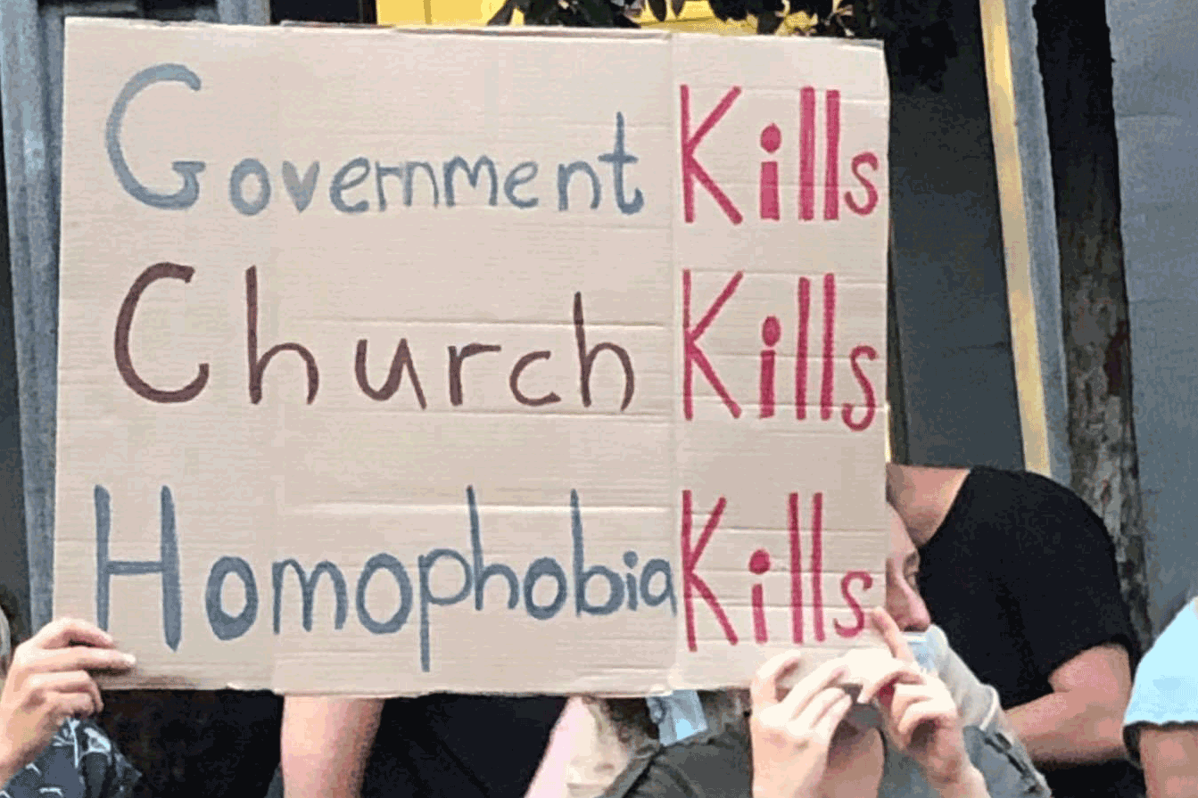 A protestor holds up a sign highlighting the role that the Georgian Orthodox Church and Government played in inciting violence against LGBTQ groups and journalists on July 5. © Anastasia Mgaloblishvili